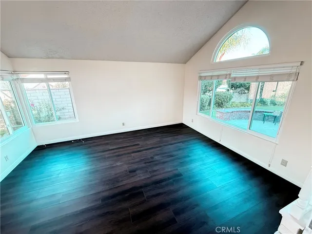 a large white kitchen with a large window a sink and cabinets