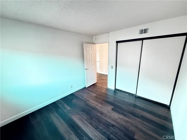 a kitchen with granite countertop a refrigerator and a sink