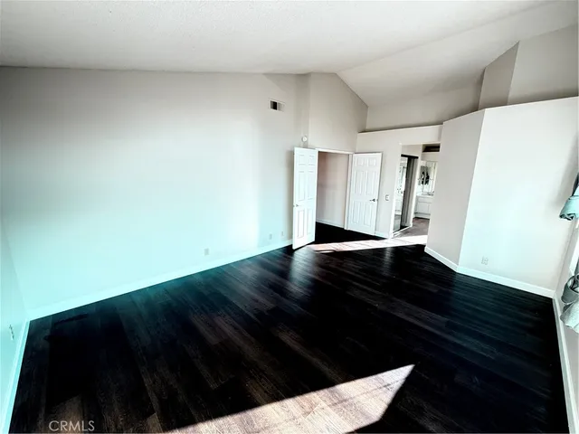 a view of a small space with wooden floor and a window