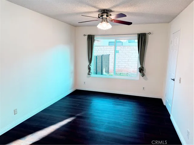a kitchen with a stove a refrigerator and white cabinets