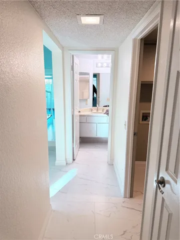 a hallway view with wooden floor and cabinet
