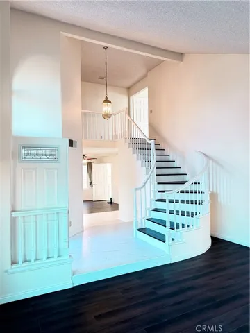 a view of an entryway with wooden floor