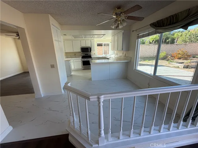 a large white kitchen with a large window