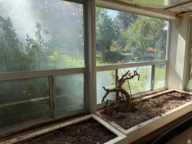 15 West 1600th Street South Mapleton, UT 84664 - Photo 14 of 22 Greenhouse featuring multiple window panes, built-in planters with soil, and views of surrounding greenery