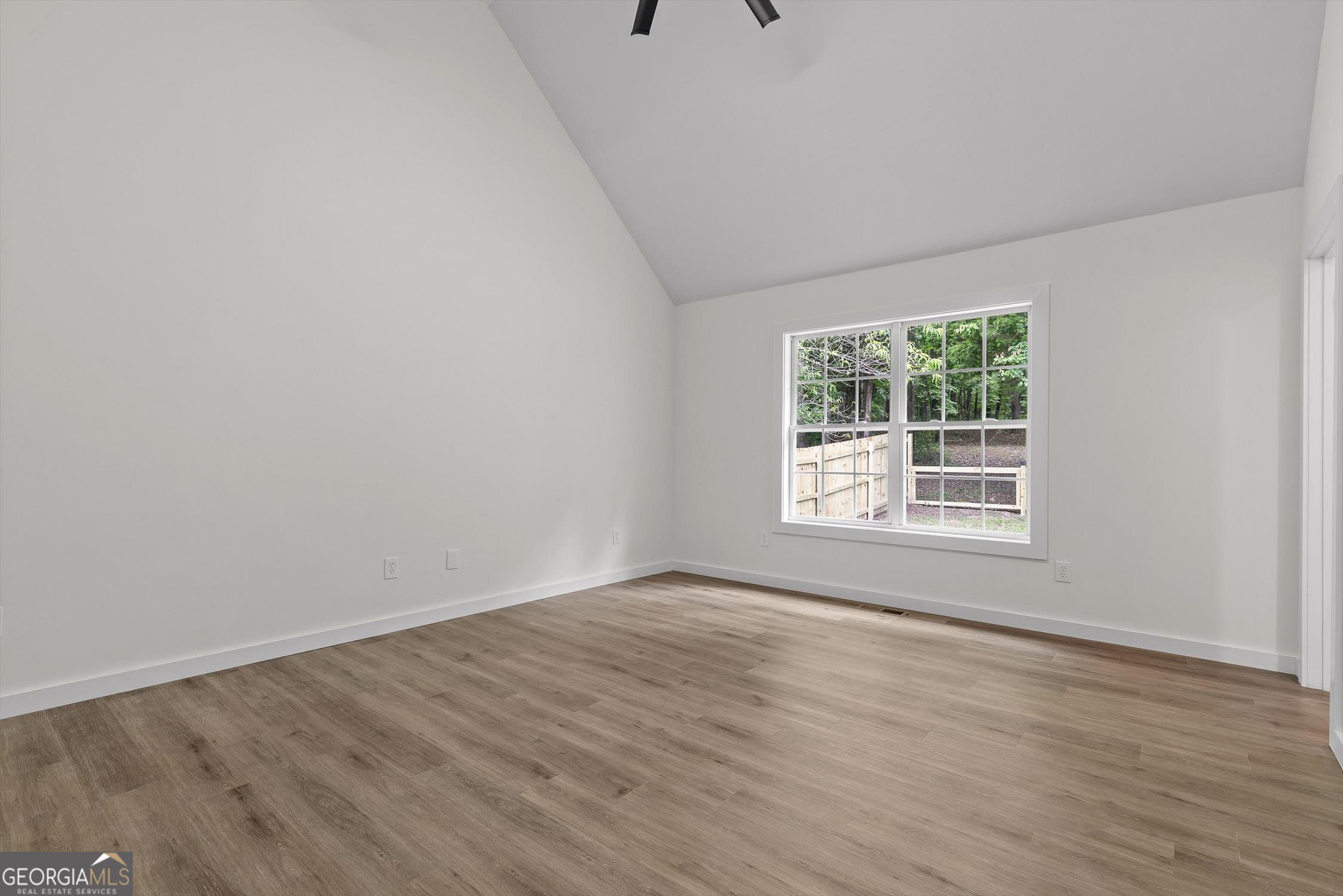 506 Condra Road Ringgold, GA 30736 - Photo 14 of 27 a view of an empty room with wooden floor and a window