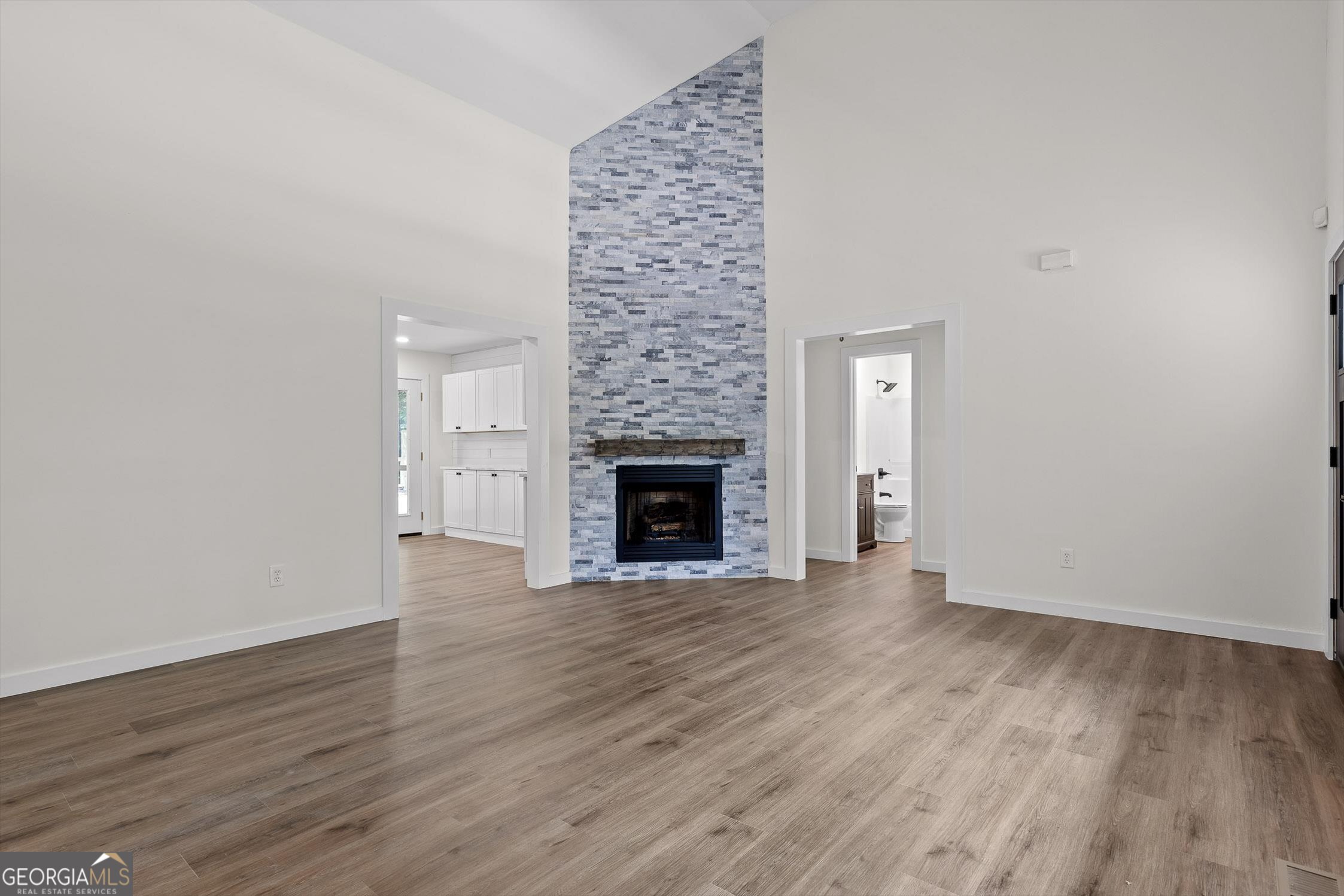 506 Condra Road Ringgold, GA 30736 - Photo 7 of 27 a view of an empty room with wooden floor and a fireplace