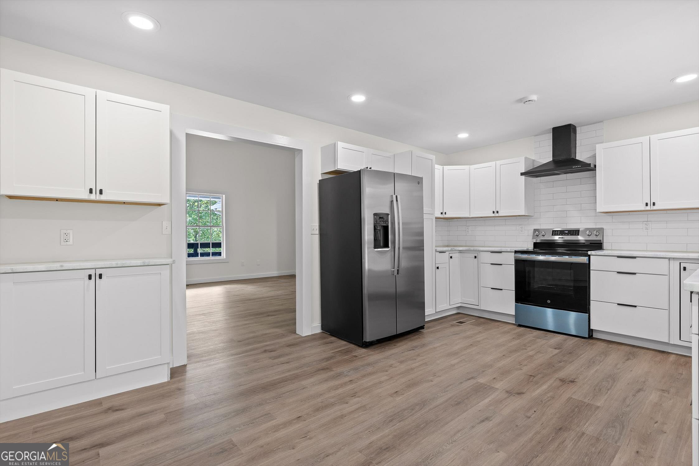 506 Condra Road Ringgold, GA 30736 - Photo 9 of 27 a kitchen with granite countertop white cabinets and stainless steel appliances