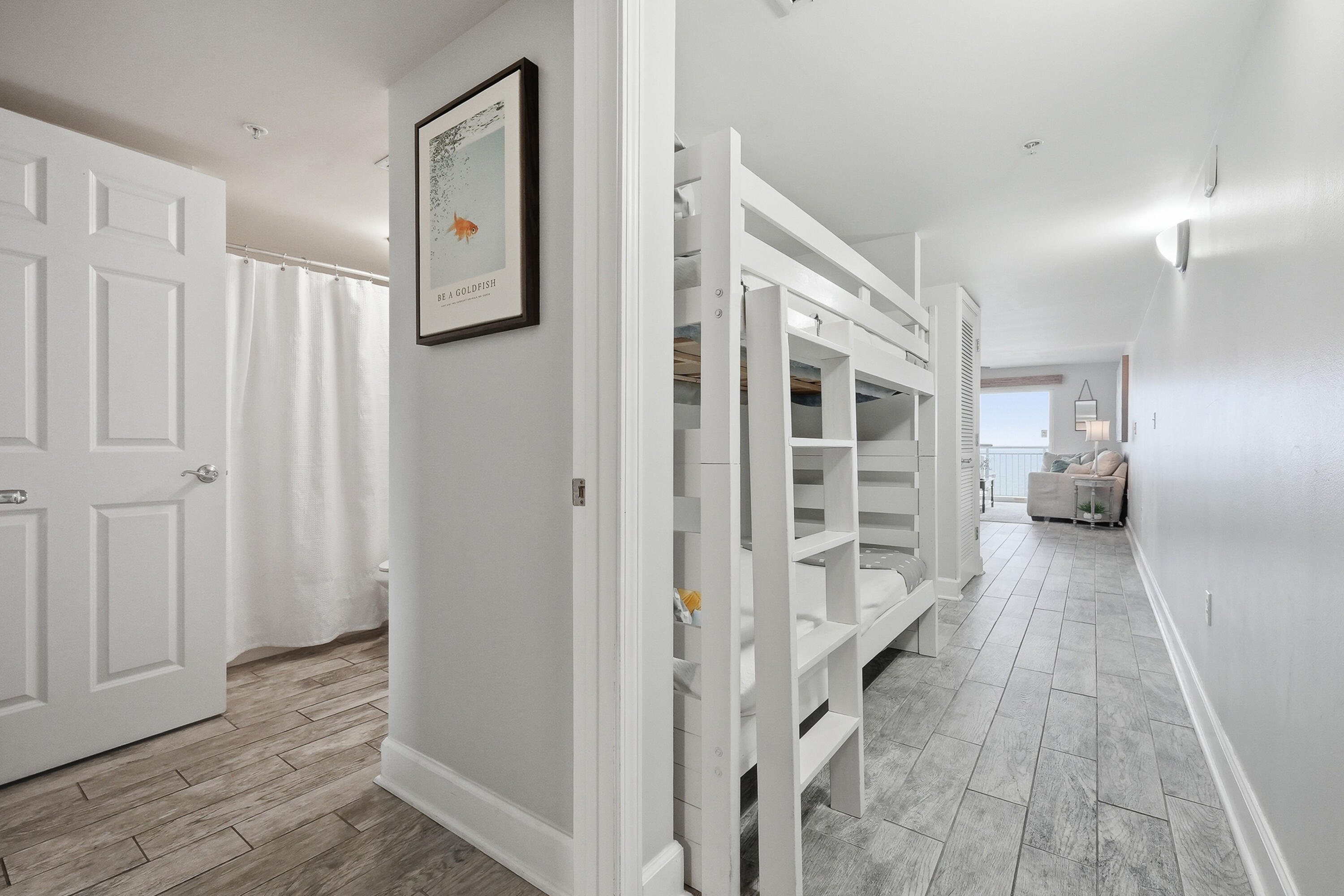 866 Santa Rosa Boulevard, Unit 506 Fort Walton Beach, FL 32548 - Photo 18 of 49 a view of a hallway with wooden floor closet and windows