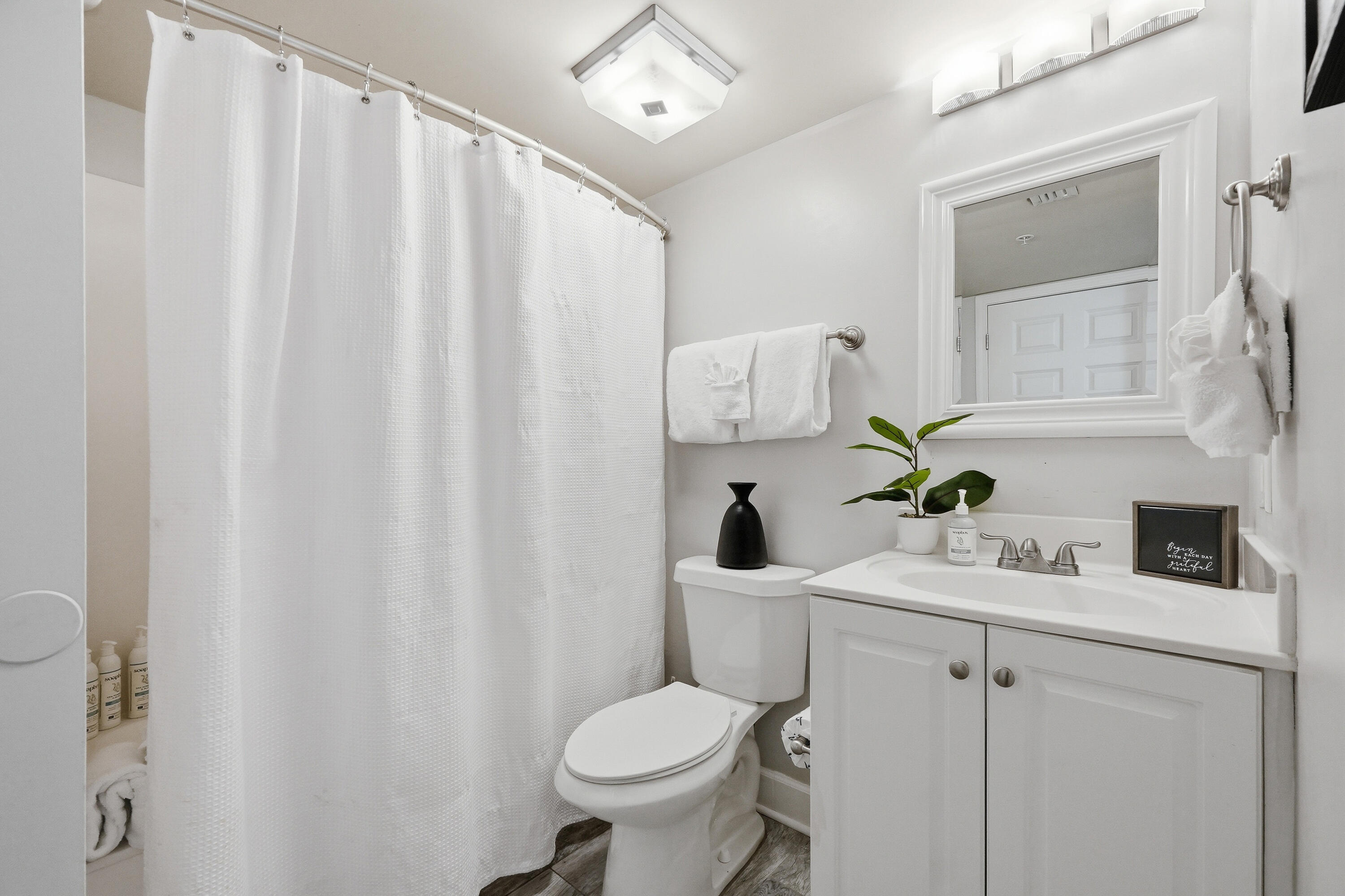 866 Santa Rosa Boulevard, Unit 506 Fort Walton Beach, FL 32548 - Photo 24 of 49 a bathroom with a sink vanity mirror and toilet