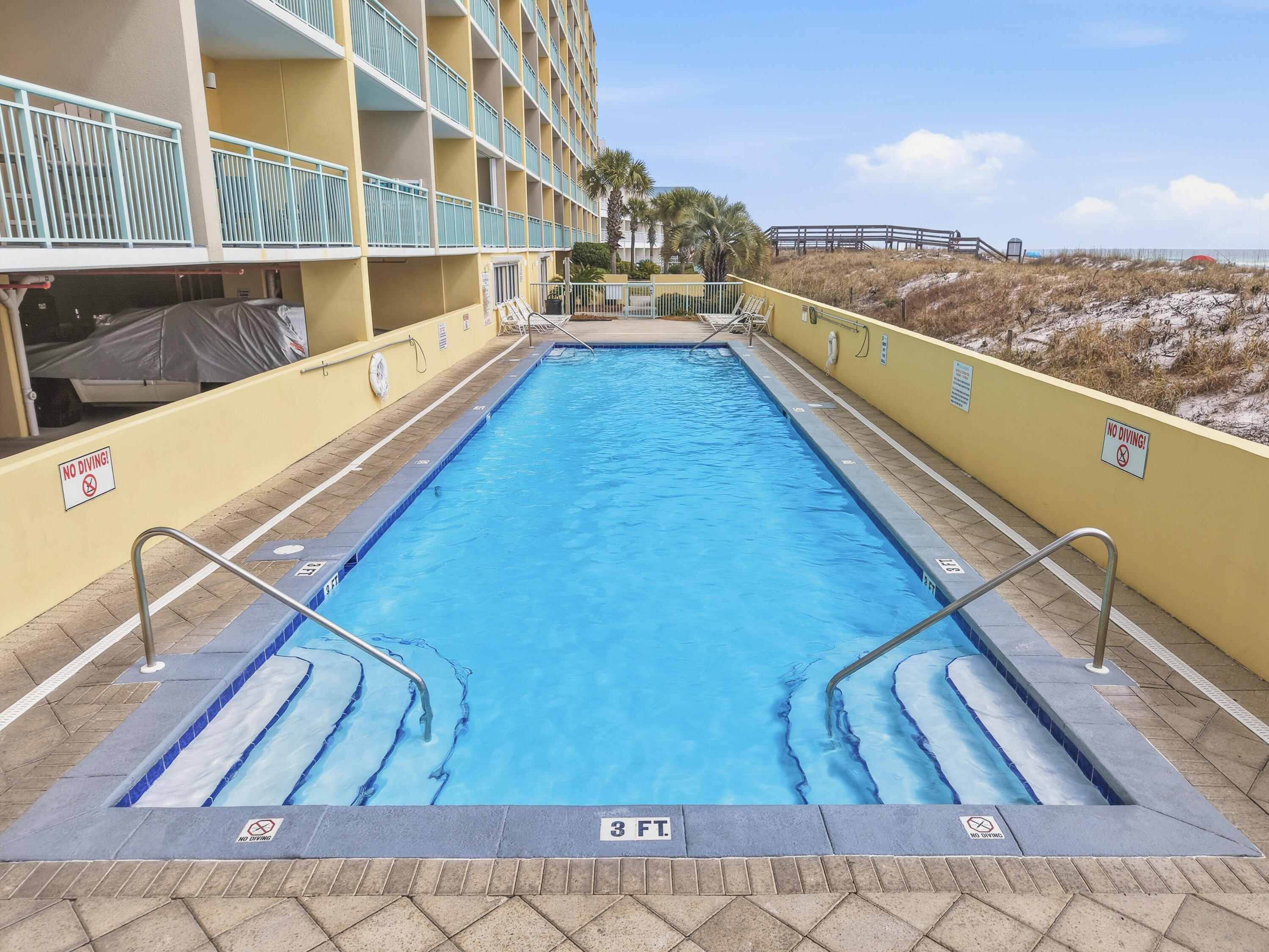 866 Santa Rosa Boulevard, Unit 506 Fort Walton Beach, FL 32548 - Photo 31 of 49 a view of balcony with two large window and wooden fence