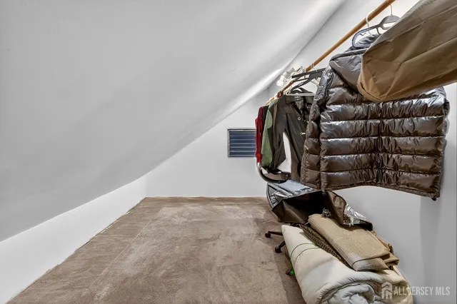 a view of walk in closet with clothes