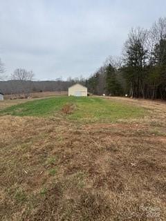 2417 Salem Church Road Bostic, NC 28018 - Photo 14 of 22 a view of a field with an trees in the background