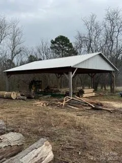 a view of house with backyard and sitting area