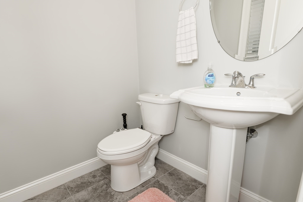 1202 Hazelwood Way, Unit 1202 Clinton, MA 01510 - Photo 17 of 38 a bathroom with a sink toilet and a mirror