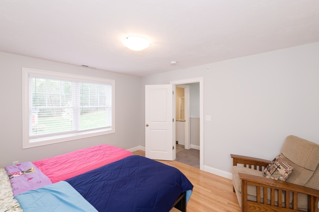 1202 Hazelwood Way, Unit 1202 Clinton, MA 01510 - Photo 24 of 38 a bedroom with a bed and a window