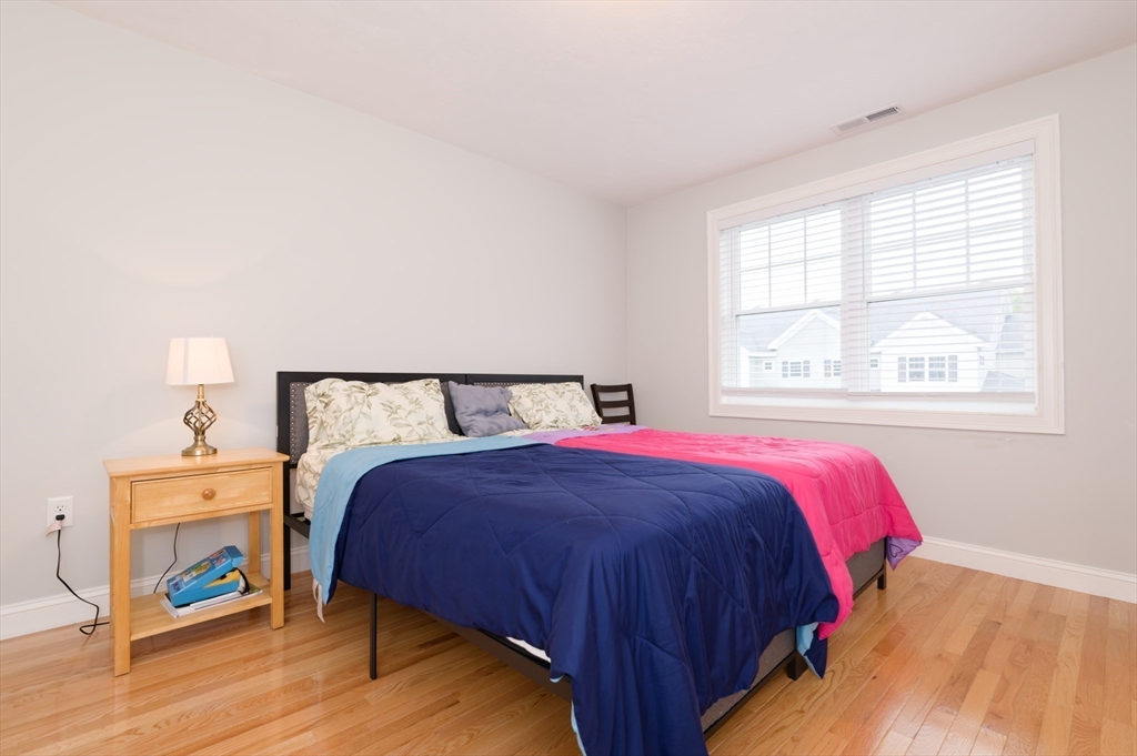 1202 Hazelwood Way, Unit 1202 Clinton, MA 01510 - Photo 25 of 38 a bedroom with a bed and a window