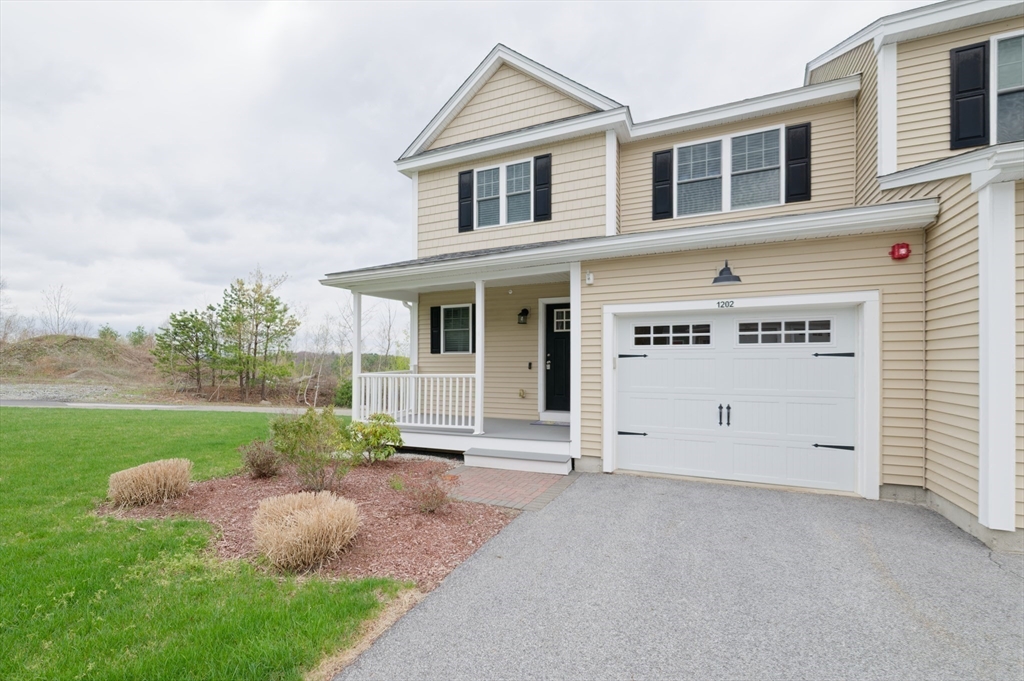 1202 Hazelwood Way, Unit 1202 Clinton, MA 01510 - Photo 33 of 38 a front view of a house with garden