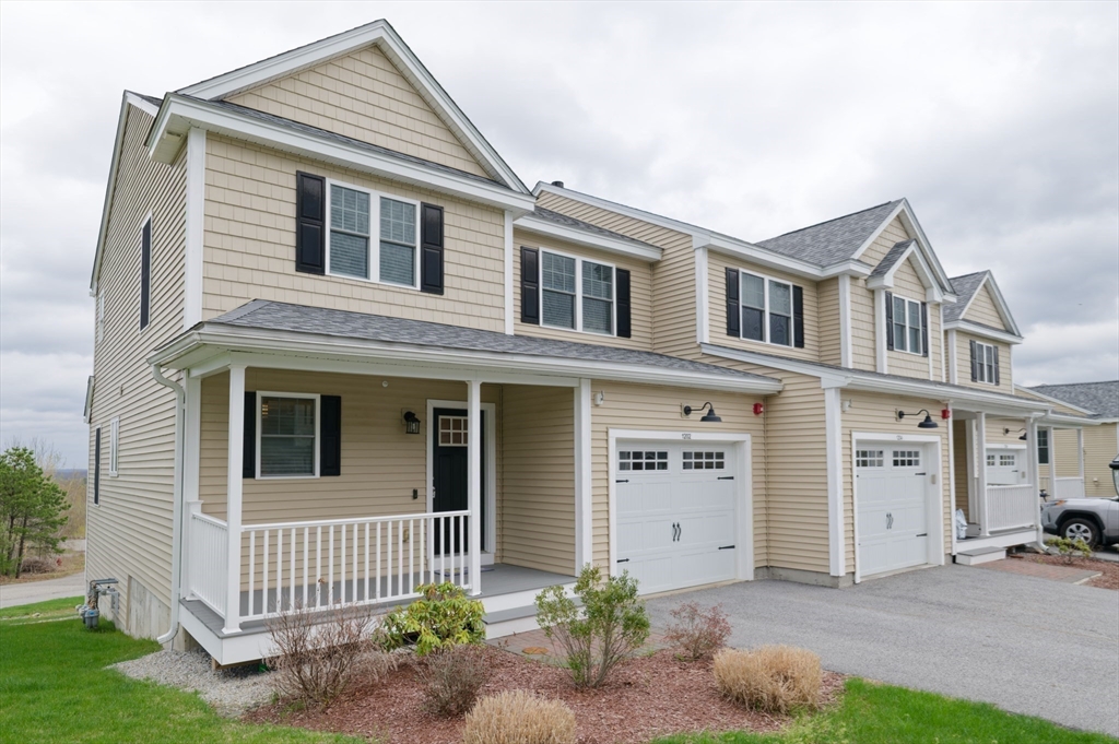 1202 Hazelwood Way, Unit 1202 Clinton, MA 01510 - Photo 34 of 38 a front view of a house with garage