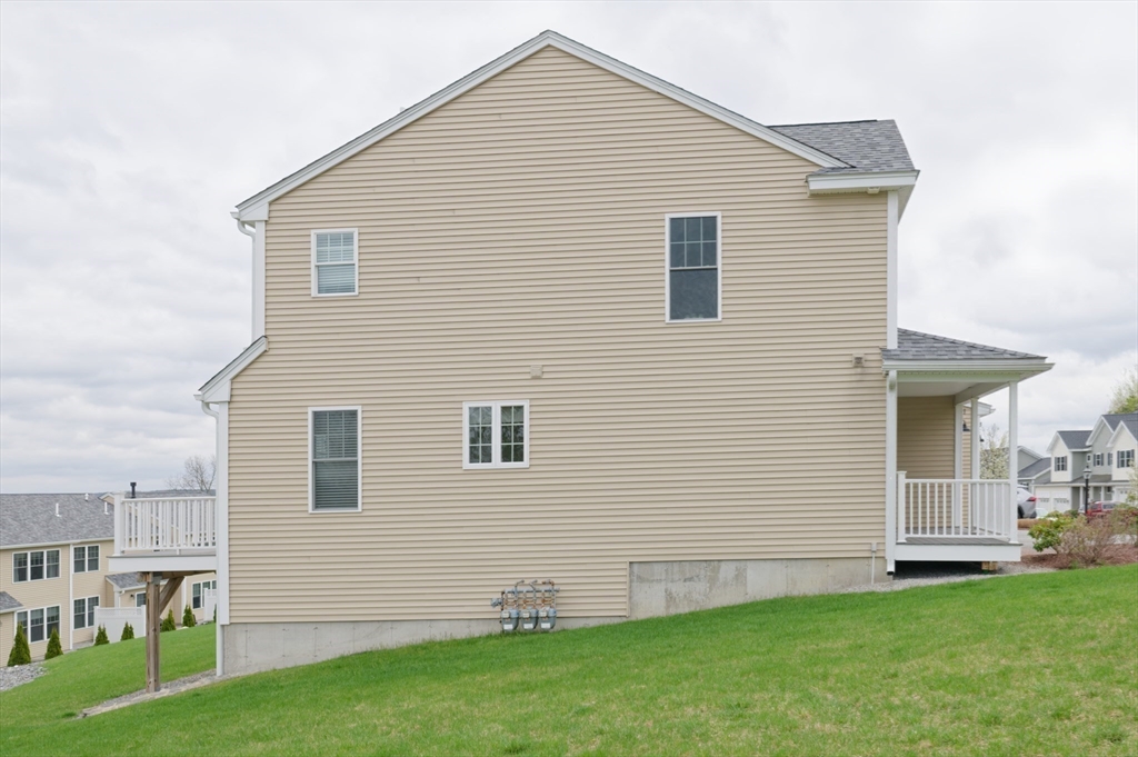 1202 Hazelwood Way, Unit 1202 Clinton, MA 01510 - Photo 35 of 38 a view of a house with a yard