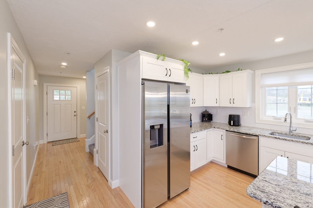 1202 Hazelwood Way, Unit 1202 Clinton, MA 01510 - Photo 4 of 38 a kitchen with stainless steel appliances a refrigerator sink and cabinets