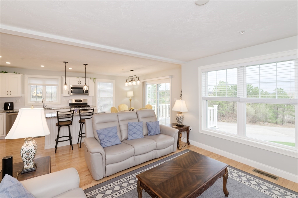 1202 Hazelwood Way, Unit 1202 Clinton, MA 01510 - Photo 5 of 38 a living room with furniture and a large window
