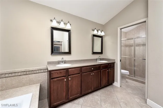 a bathroom with a double vanity sink and a mirror