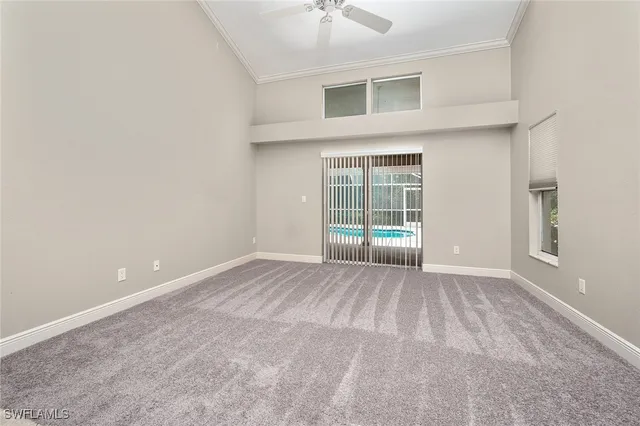 an empty room with windows and entrance