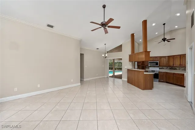 a kitchen with kitchen island white cabinets and stainless steel appliances