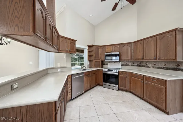a kitchen with stainless steel appliances granite countertop a stove sink and cabinets