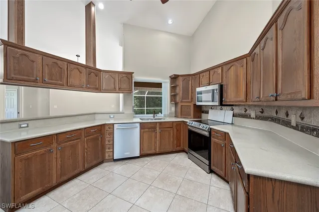 a kitchen with stainless steel appliances granite countertop a sink counter space cabinets and a stove