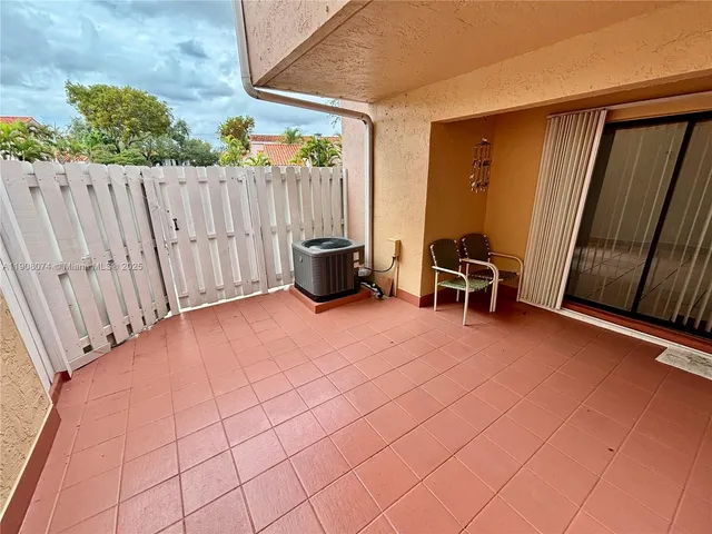 a view of an outdoor space with porch area with furniture