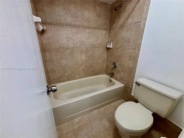 a white toilet sitting next to a bath tub