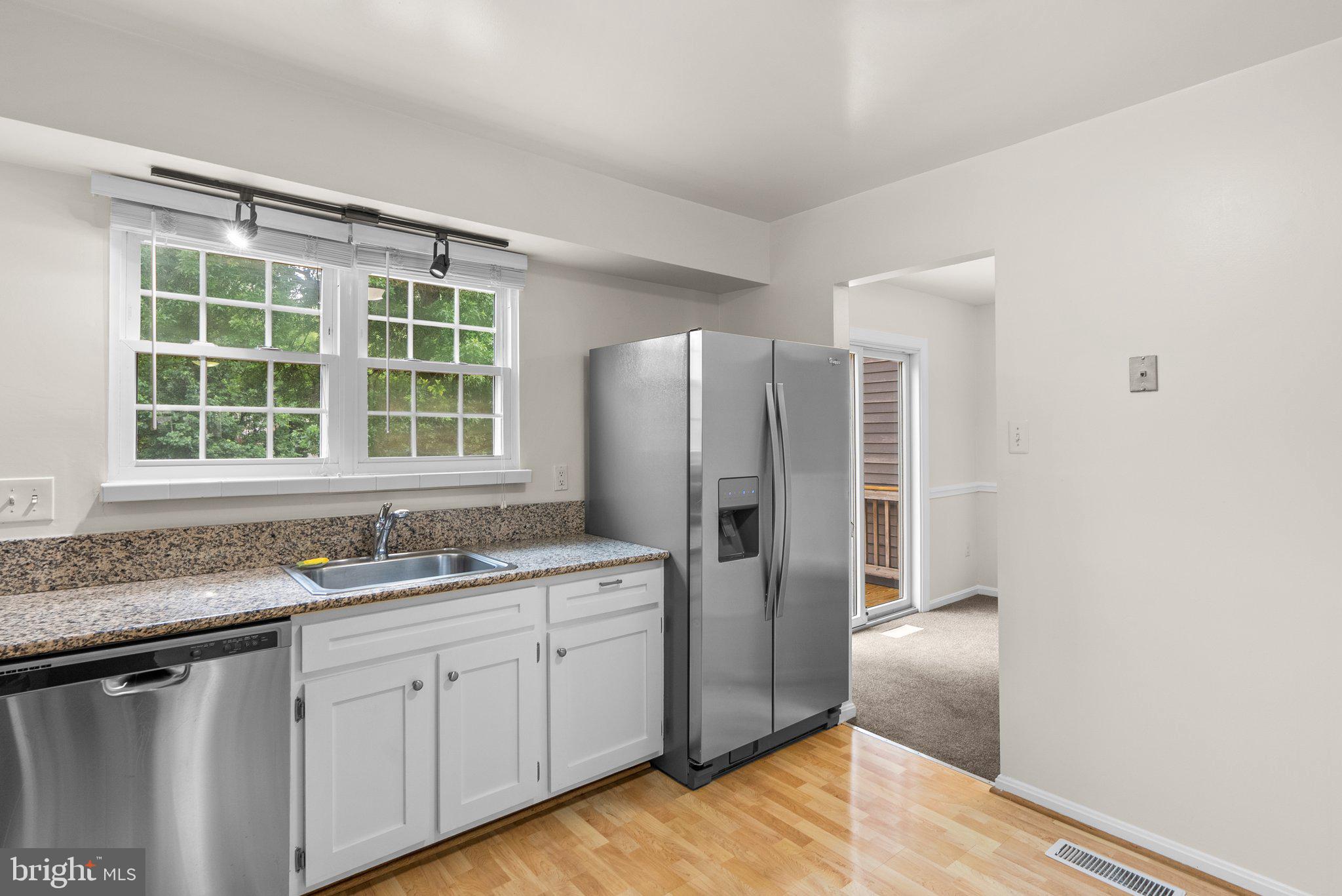 17513 Longview Lane Olney, MD 20832 - Photo 24 of 51 a kitchen with stainless steel appliances granite countertop a refrigerator and a sink