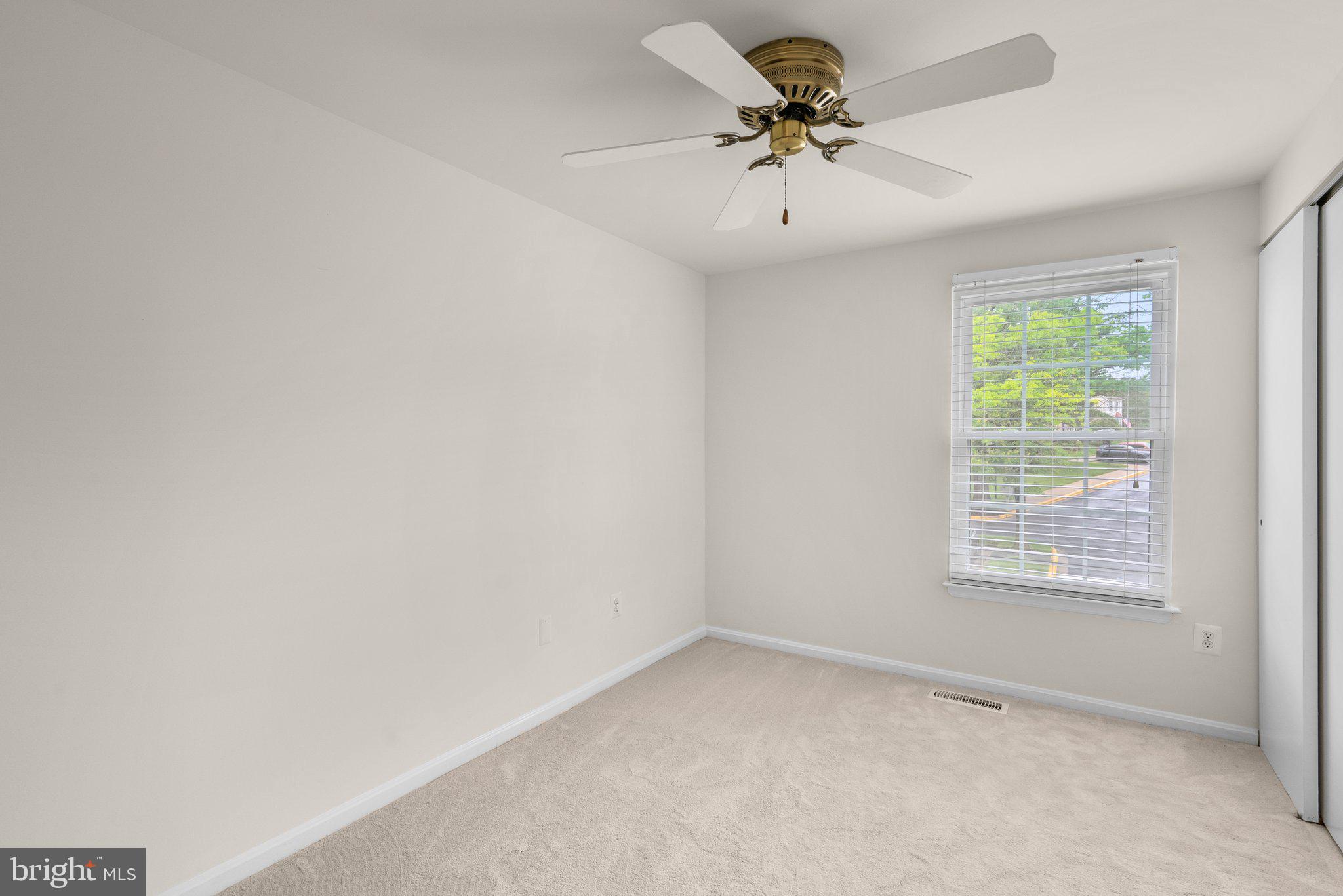 17513 Longview Lane Olney, MD 20832 - Photo 31 of 51 an empty room with a window and a fan