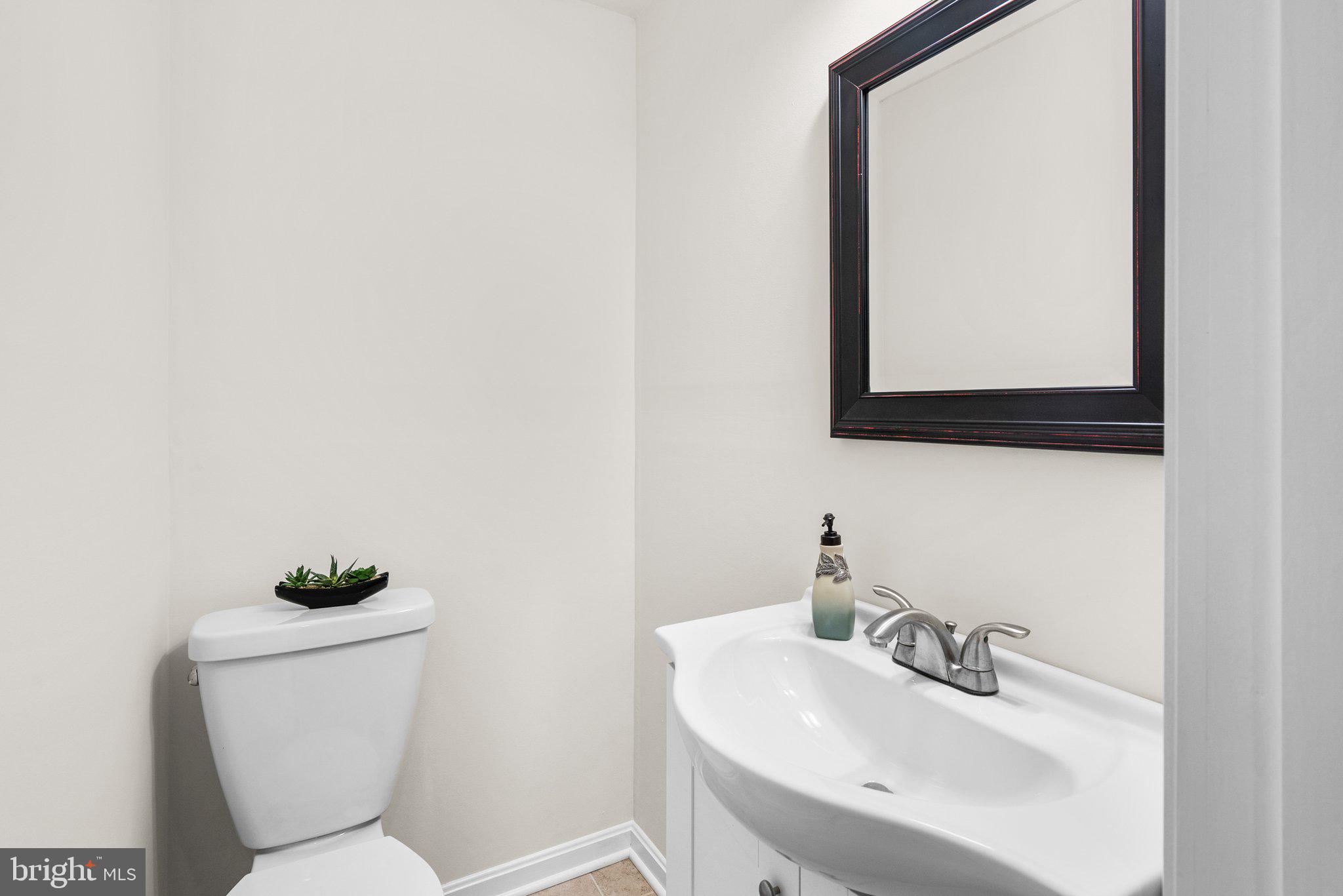 17513 Longview Lane Olney, MD 20832 - Photo 40 of 51 a bathroom with a toilet sink and mirror
