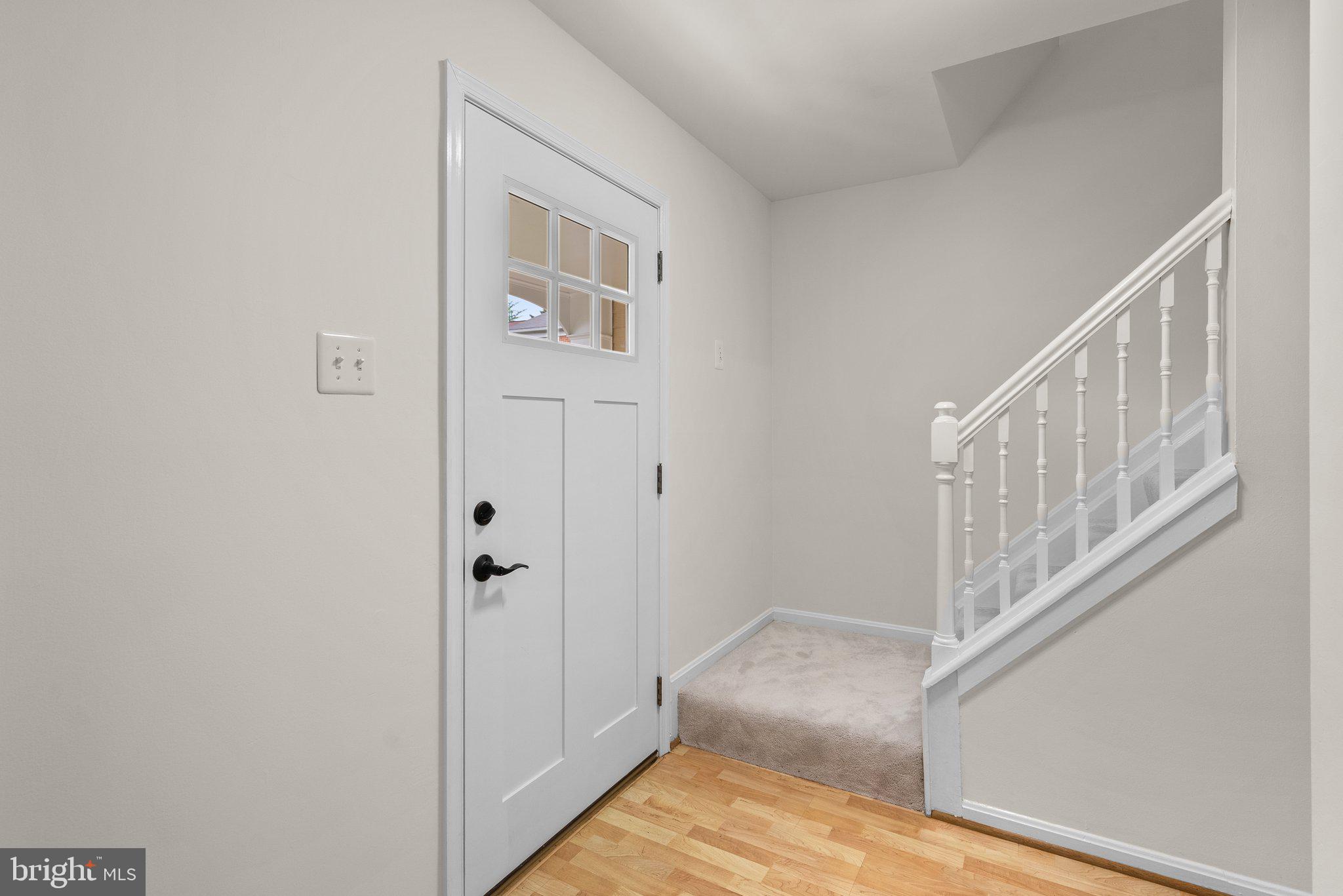 17513 Longview Lane Olney, MD 20832 - Photo 10 of 51 a view of a hallway with wooden floor and entryway