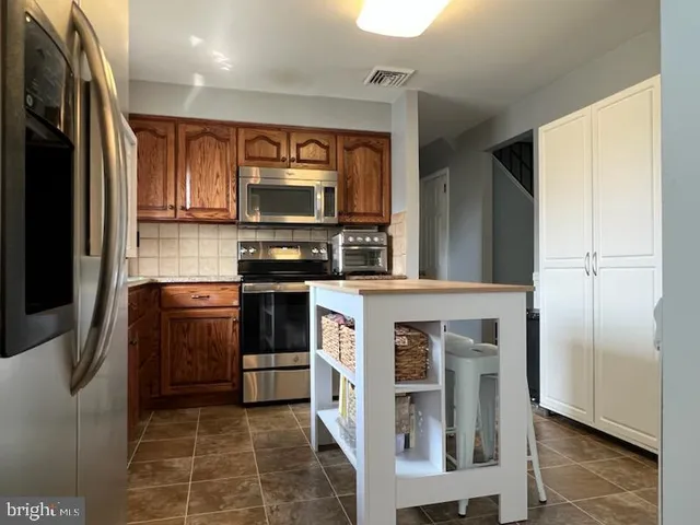 a kitchen with stainless steel appliances granite countertop a granite counter tops and a stove top oven