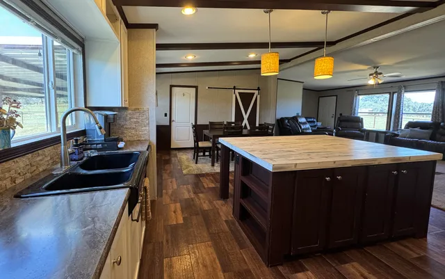 a kitchen with a sink stove and cabinets