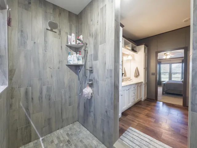 a bathroom with a double vanity sink and shower