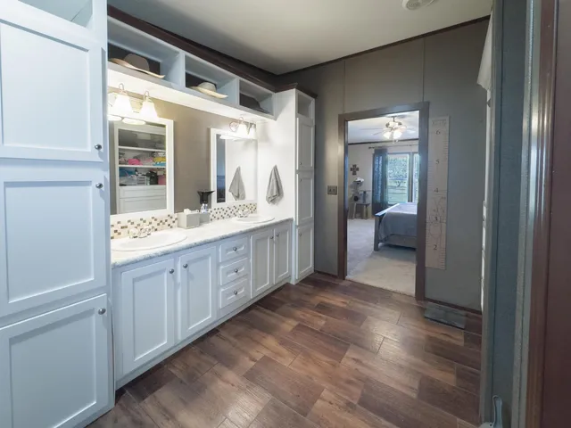 a spacious bathroom with a double vanity sink and a mirror