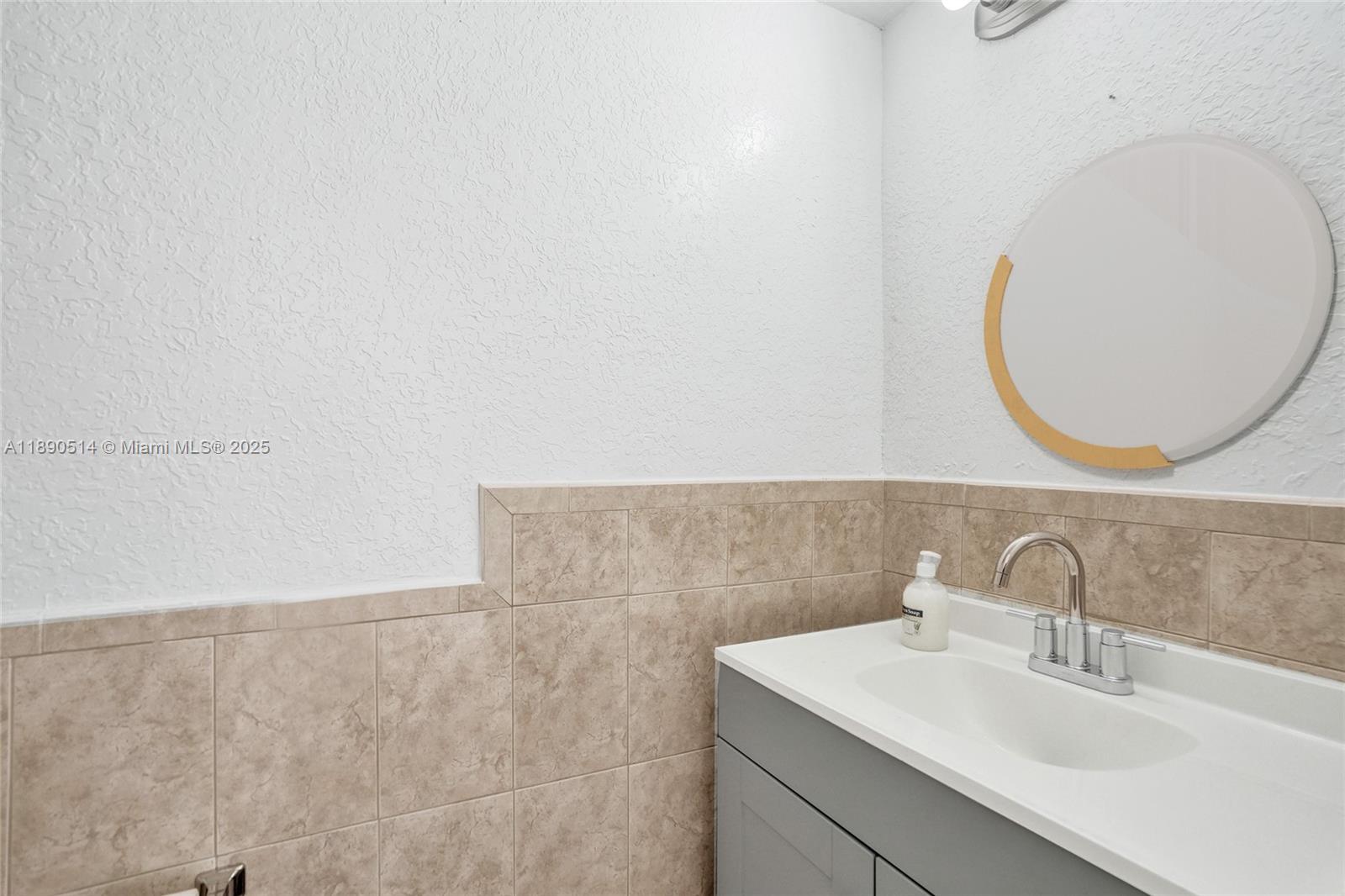 4026 Inverrary Drive, Unit 8A Lauderhill, FL 33319 - Photo 18 of 50 a bathroom with a sink and a mirror