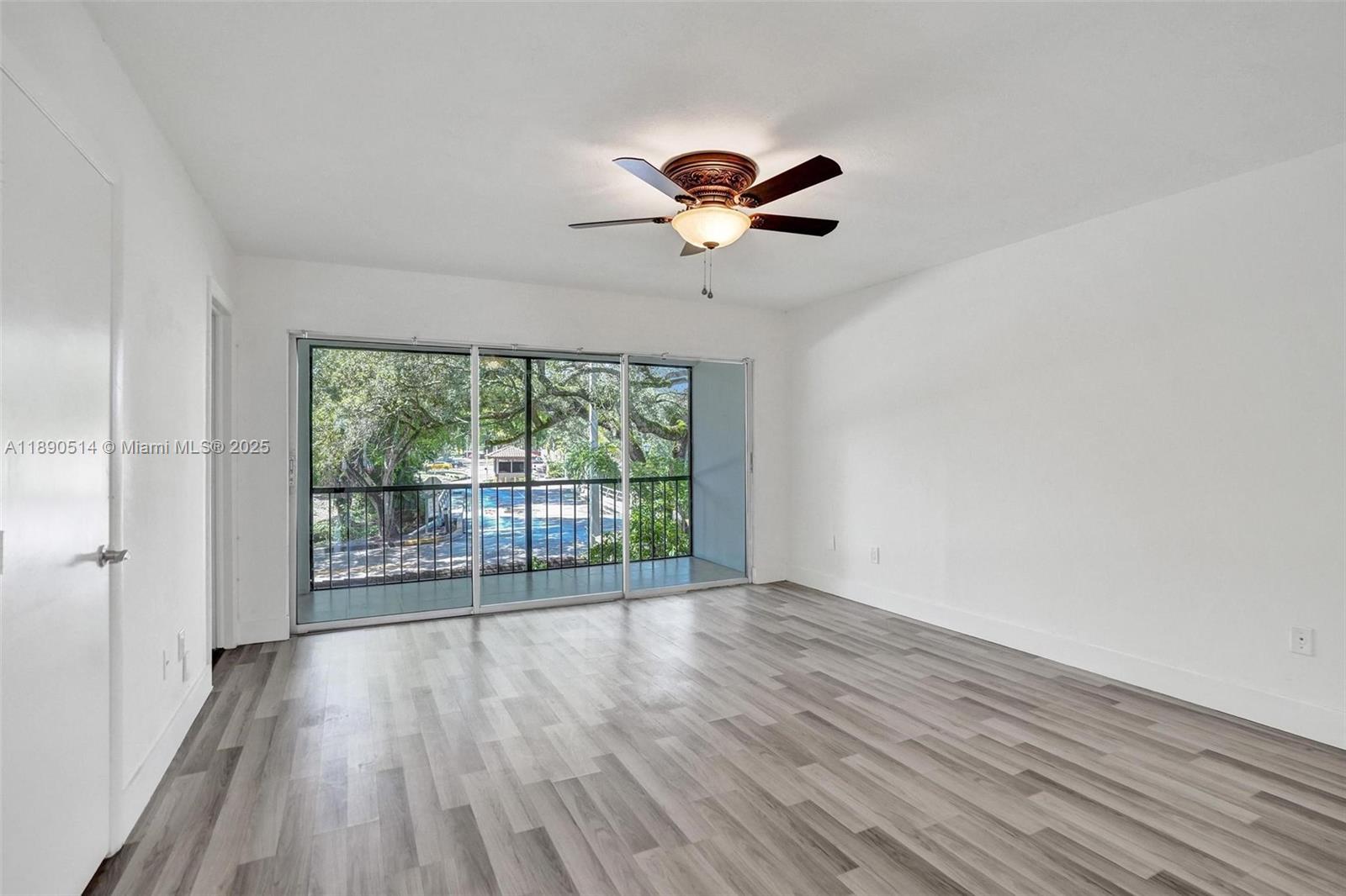 4026 Inverrary Drive, Unit 8A Lauderhill, FL 33319 - Photo 24 of 50 a view of an empty room with wooden floor and a window