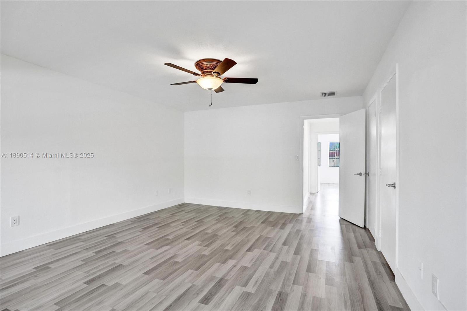 4026 Inverrary Drive, Unit 8A Lauderhill, FL 33319 - Photo 25 of 50 a view of a room with wooden floor and a ceiling fan