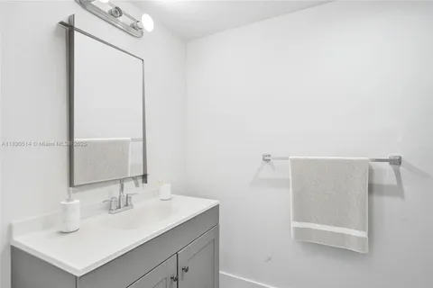 a bathroom with a sink a mirror and a shower