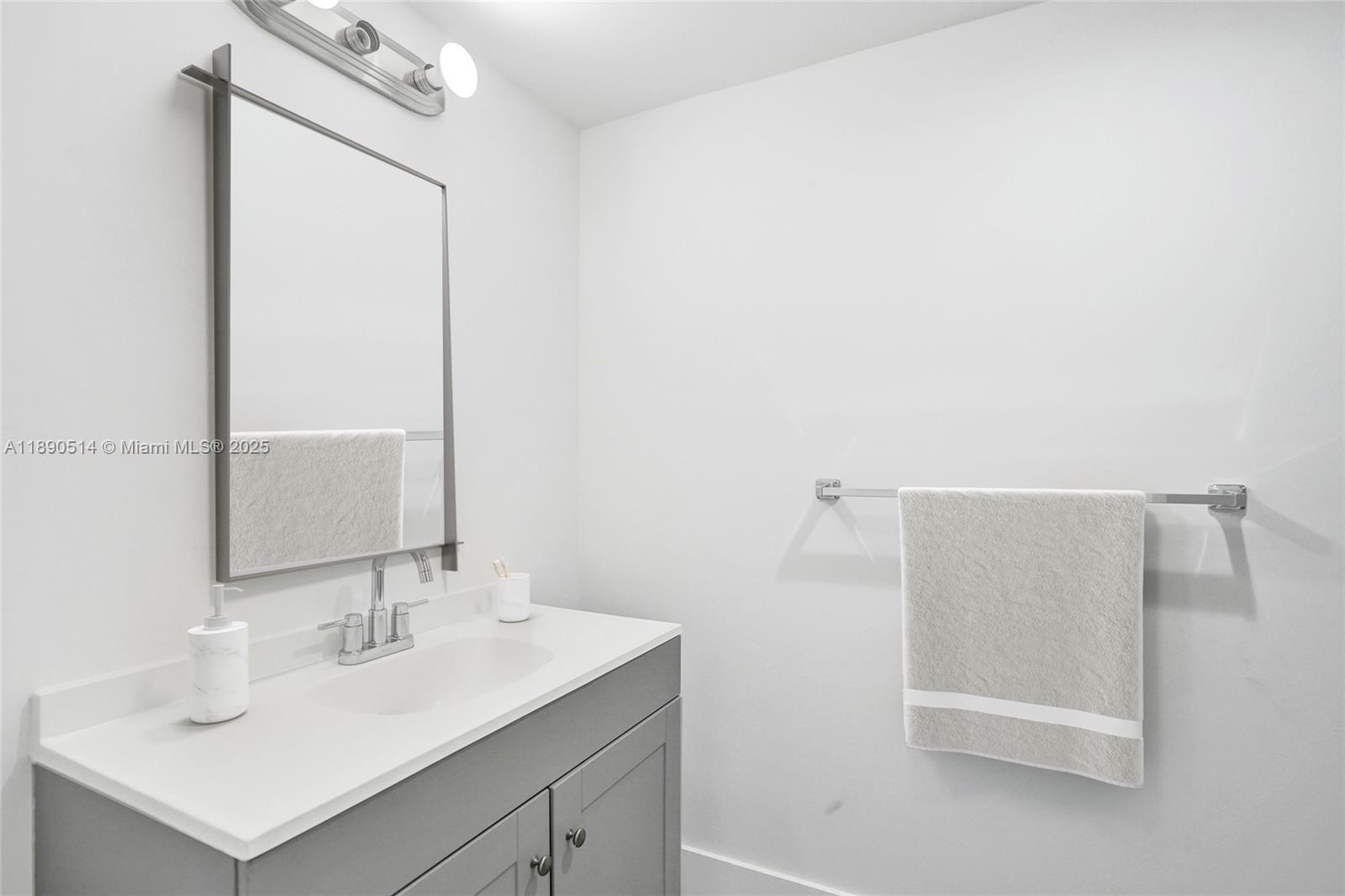 4026 Inverrary Drive, Unit 8A Lauderhill, FL 33319 - Photo 27 of 50 a bathroom with a sink a mirror and a shower