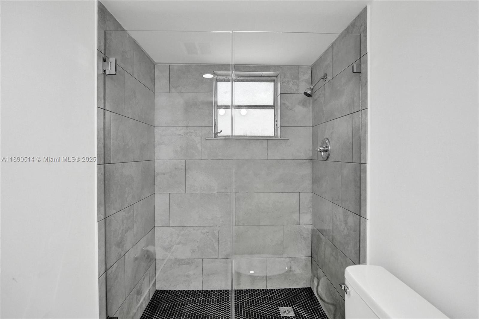 4026 Inverrary Drive, Unit 8A Lauderhill, FL 33319 - Photo 28 of 50 a bathroom with a window a toilet and shower