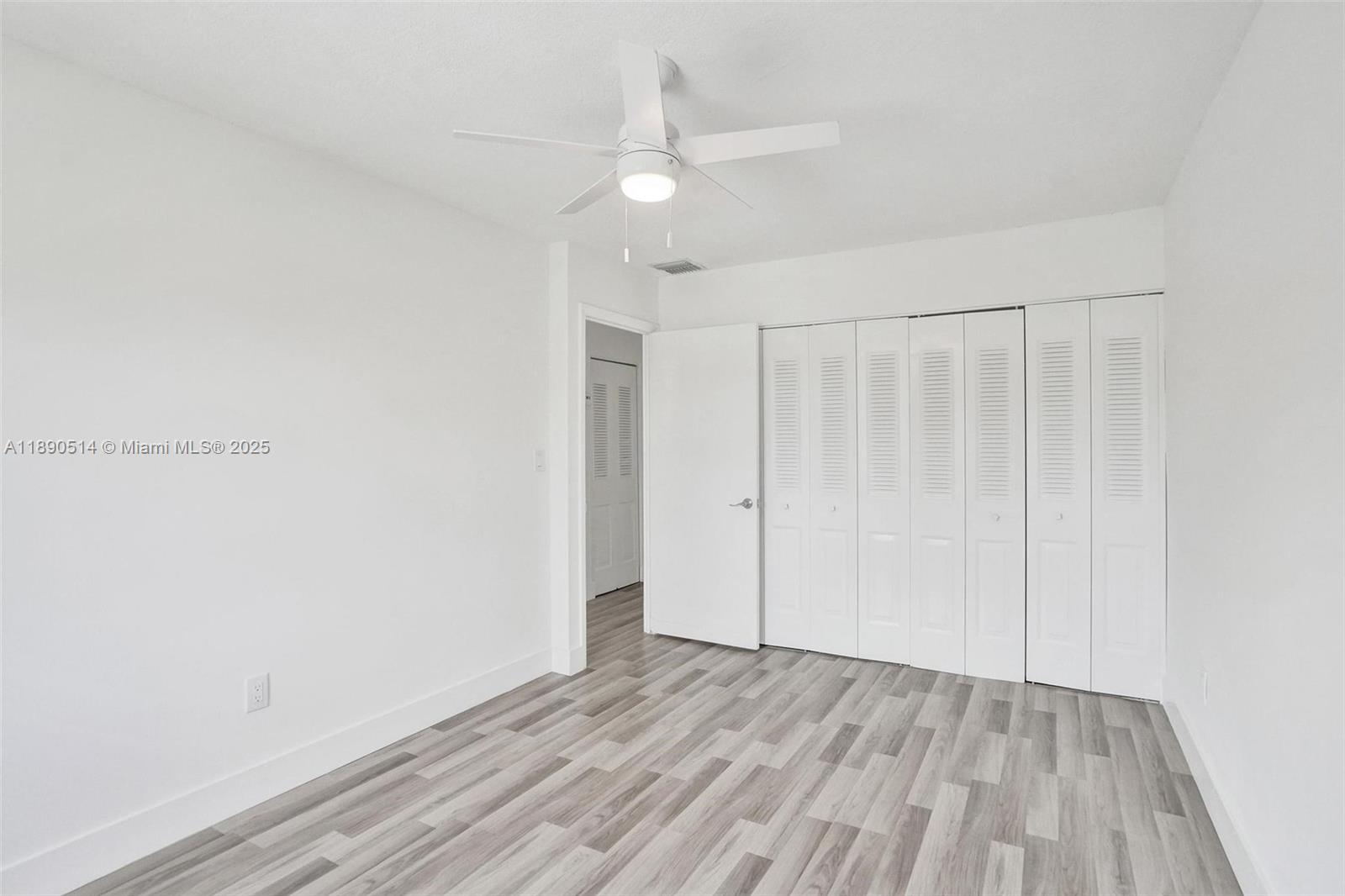 4026 Inverrary Drive, Unit 8A Lauderhill, FL 33319 - Photo 36 of 50 a view of an empty room with wooden floor