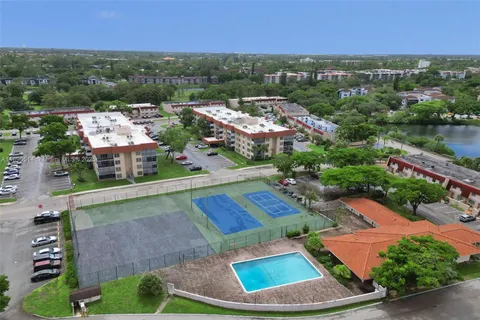 an aerial view of residential houses with outdoor space and river