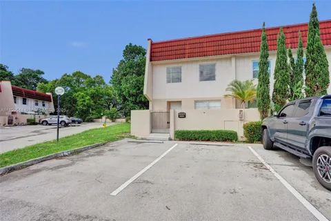 a front view of a house with a yard and a garage