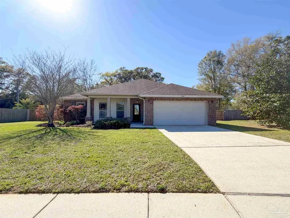 a front view of a house with a garden and yard